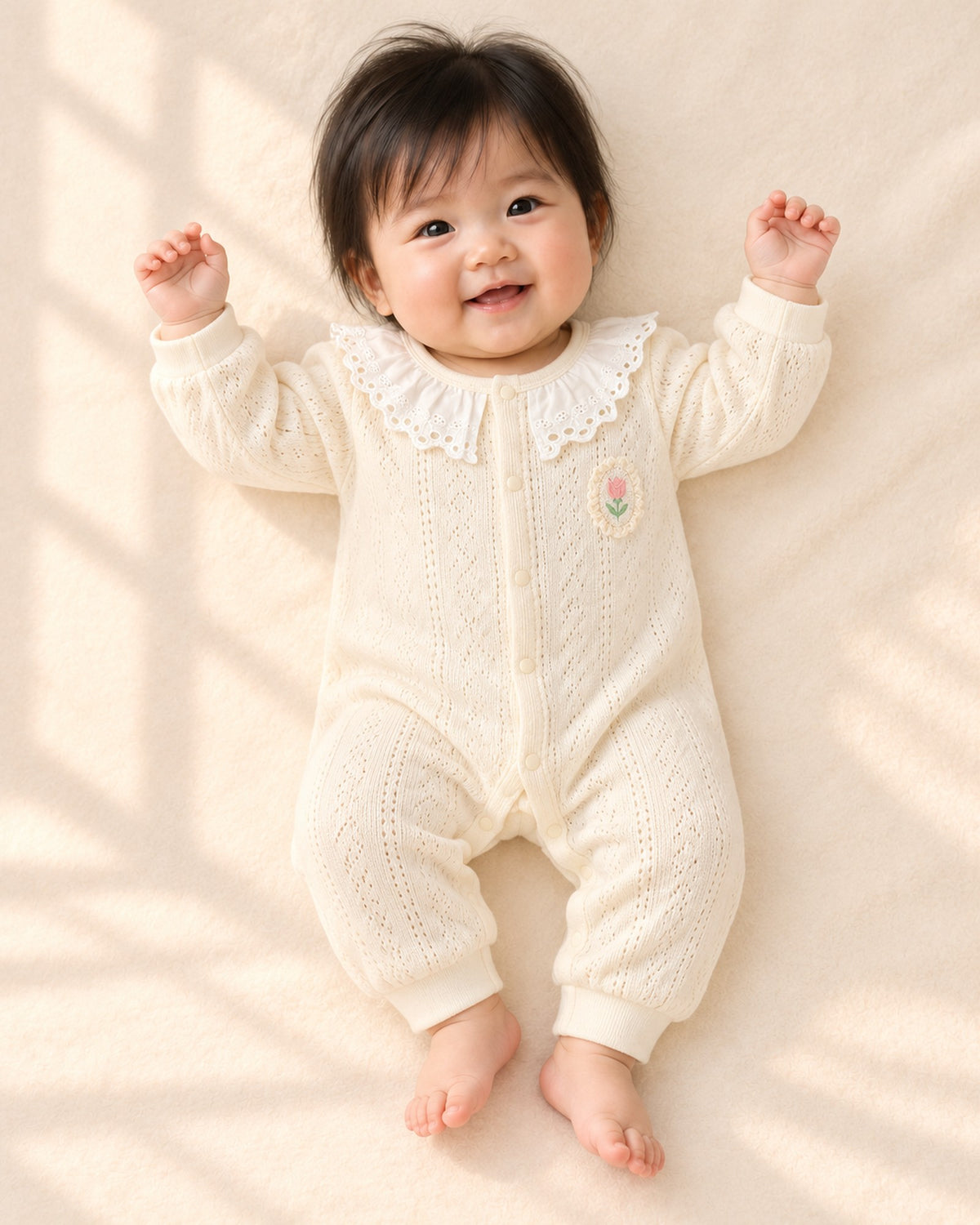 Front view of the cream pointelle romper – Cream