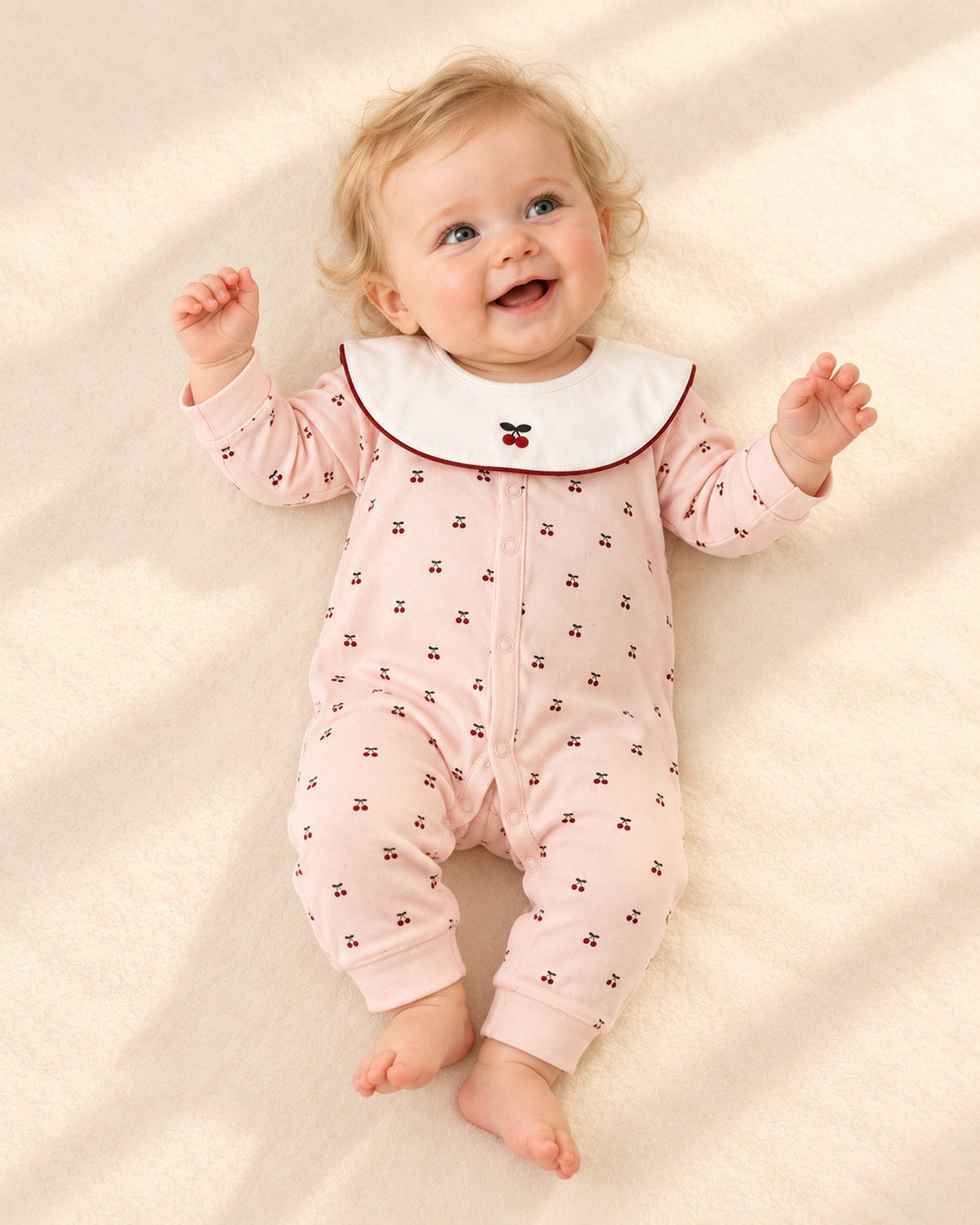 Front view of the cherry romper with front snaps – Pink Cherry