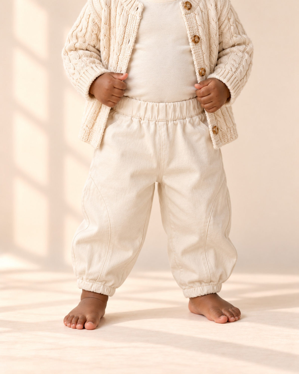 Cream cotton bloomer pants with curved seams and gathered ankle cuffs