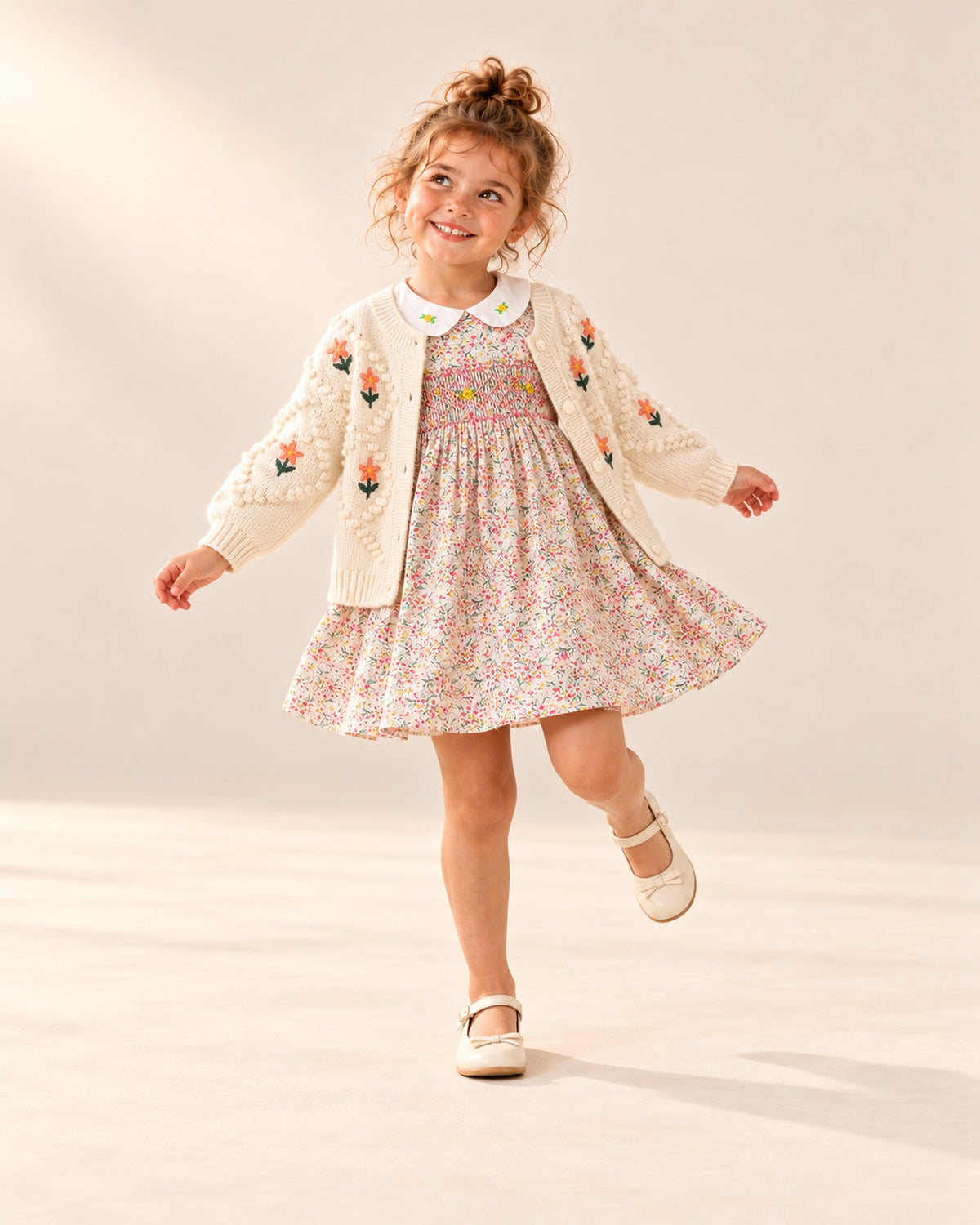 Girl standing playfully in the pink floral smocked dress – Pink Floral