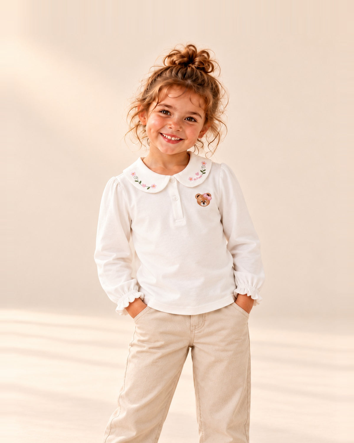 White cotton top with a flower-embroidered Peter Pan collar and a small bear on the chest