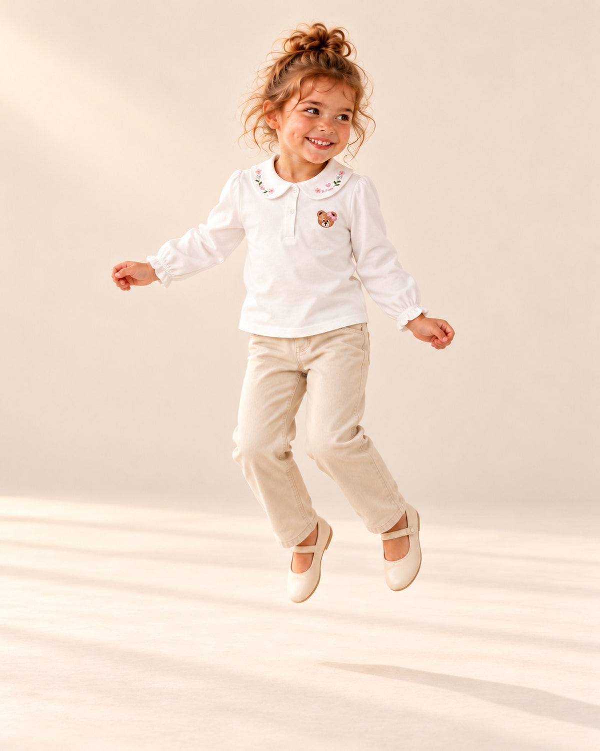 Girl in the brown corduroy pinafore with the embroidered collar and bear showing, head to toe – White