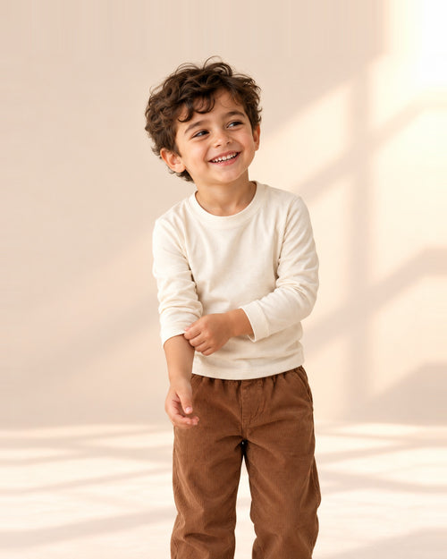 Boy smiling in the Alfie brown corduroy pull-on pants – Brown
