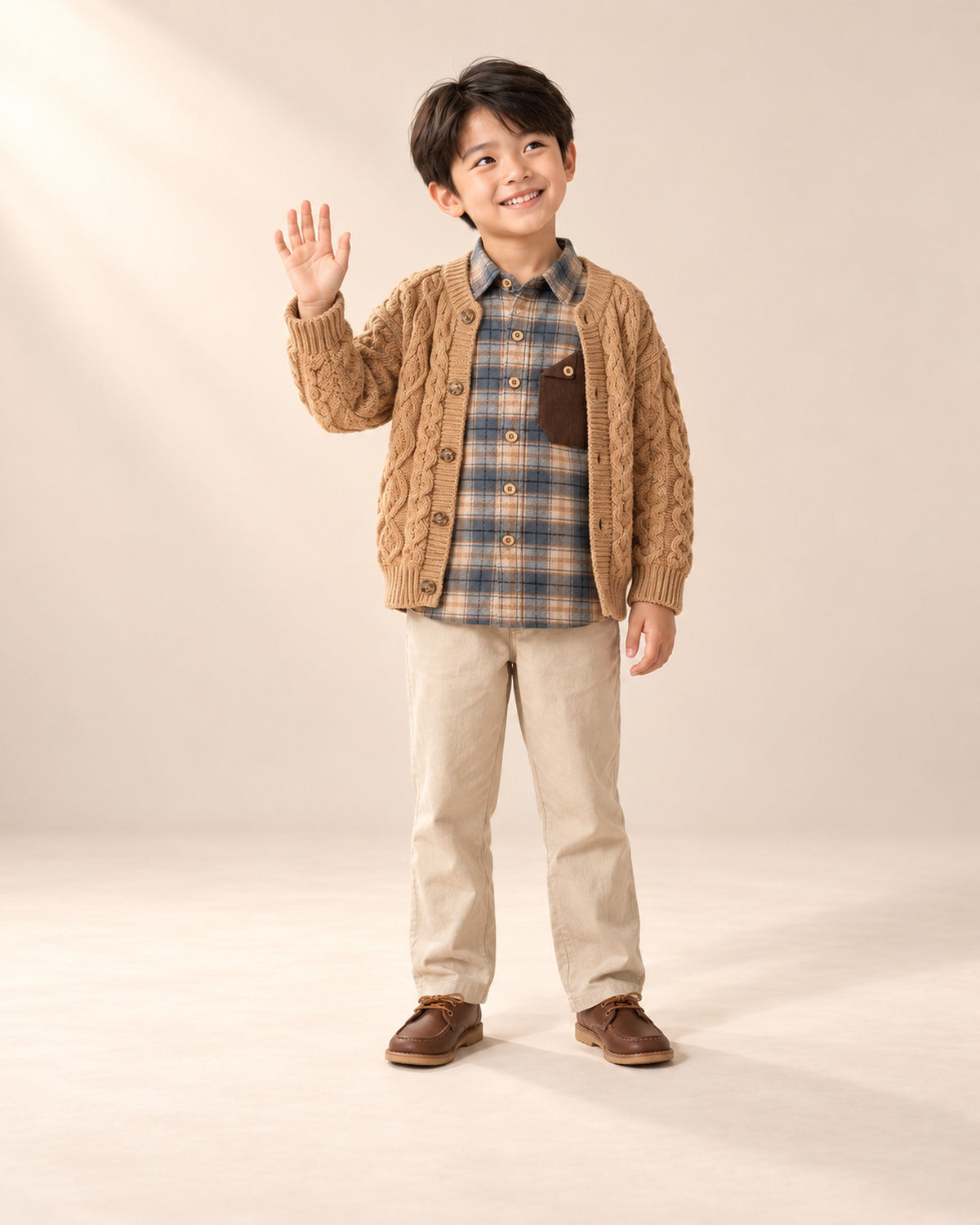 Full-length front view of the camel cable cardigan, paired with the plaid flannel shirt with cord pocket – Camel