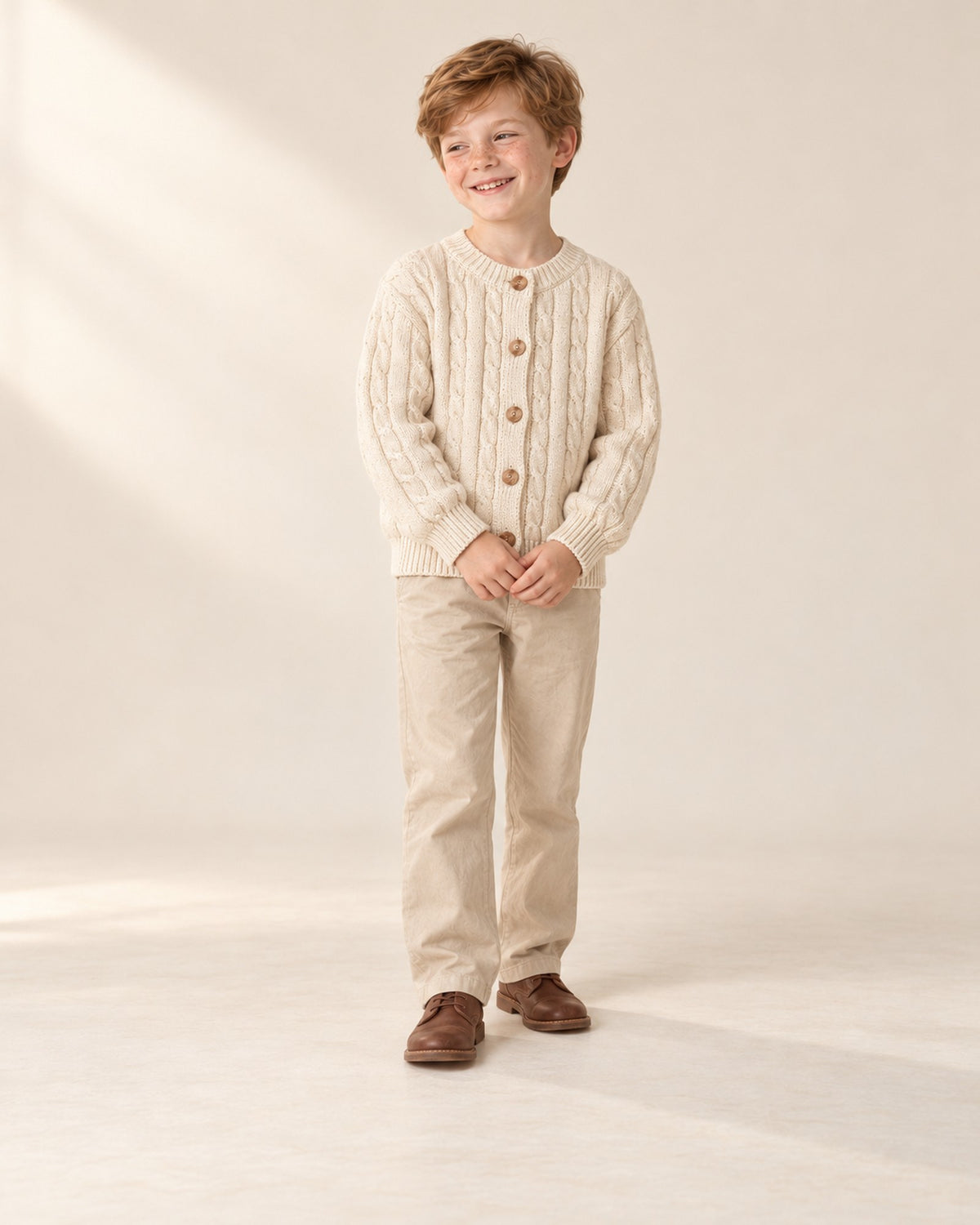 Front view of the cream cable knit cardigan, full length – Cream