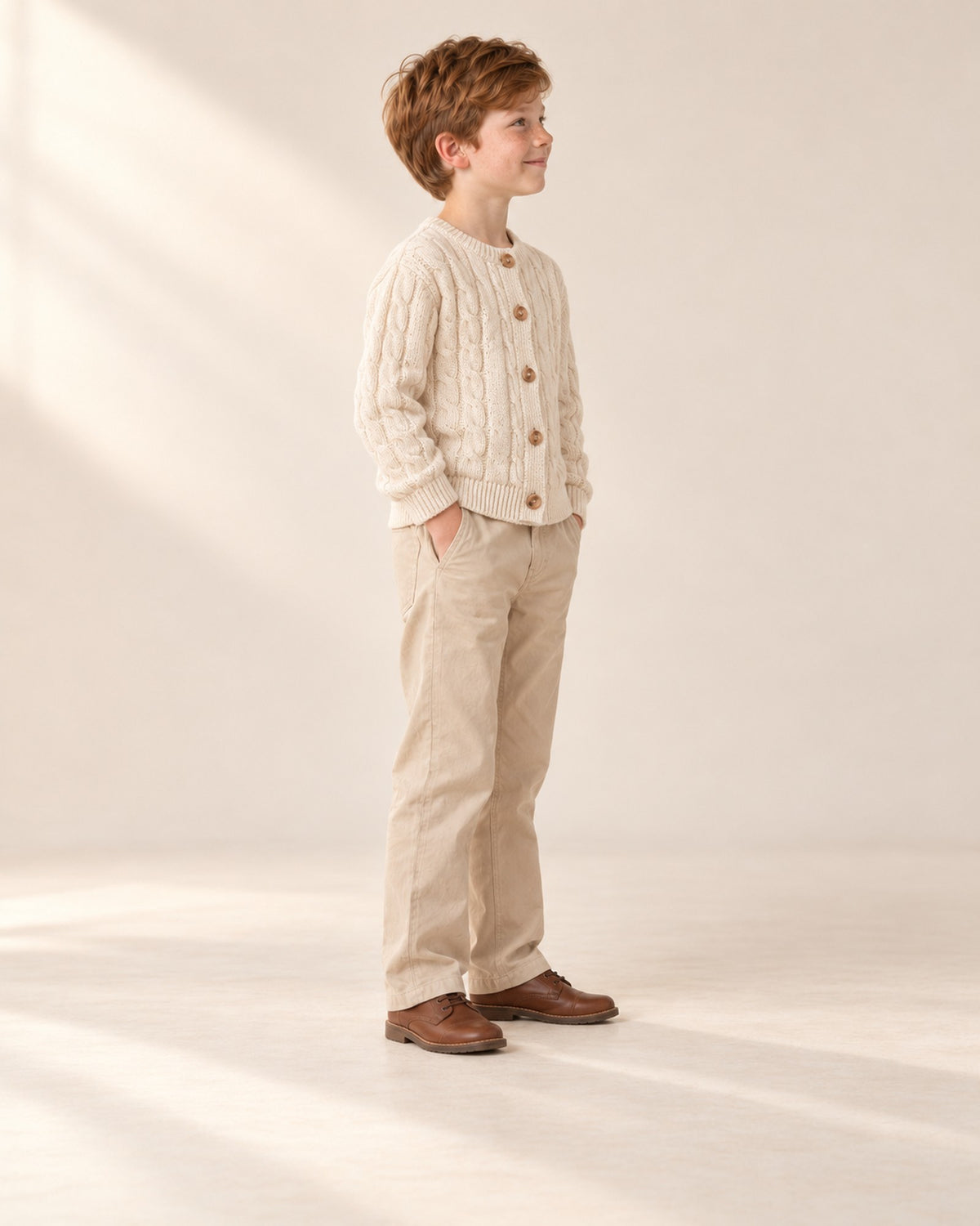 Side view of the cream cardigan showing the ribbed hem – Cream