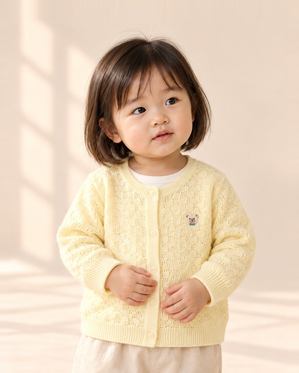 Toddler in the June butter-yellow knit cardigan with a tiny bear – Butter Yellow