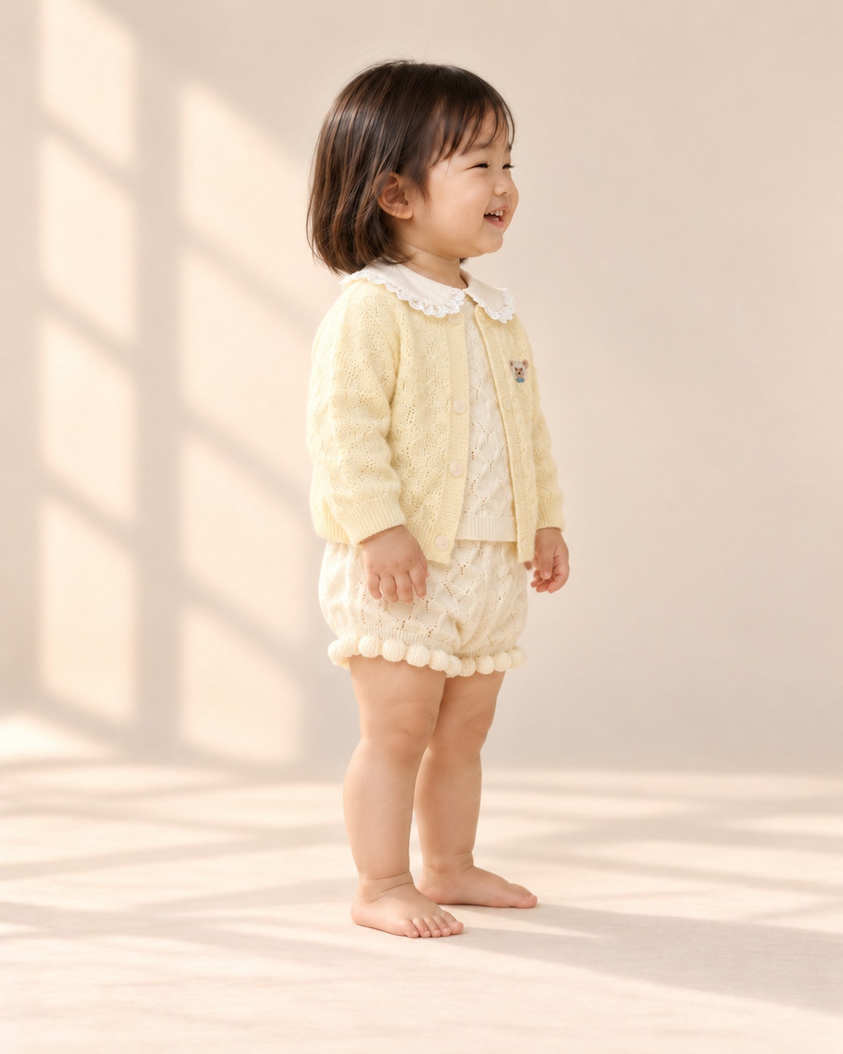 Side view of the butter knit bear cardigan worn with the popcorn knit set with lace collar – Butter Yellow