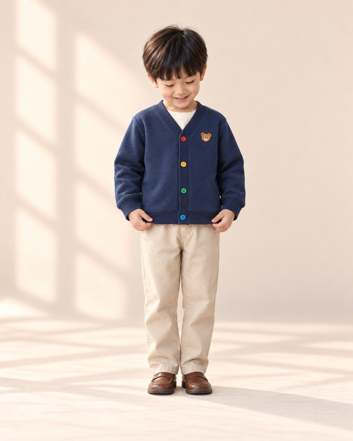 Front view of the navy bear cardigan, full length – Navy