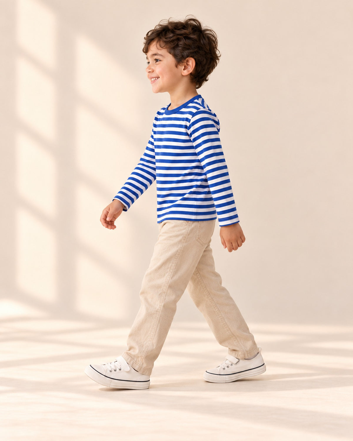 Side view of the white canvas sneaker with its navy-striped sole – White