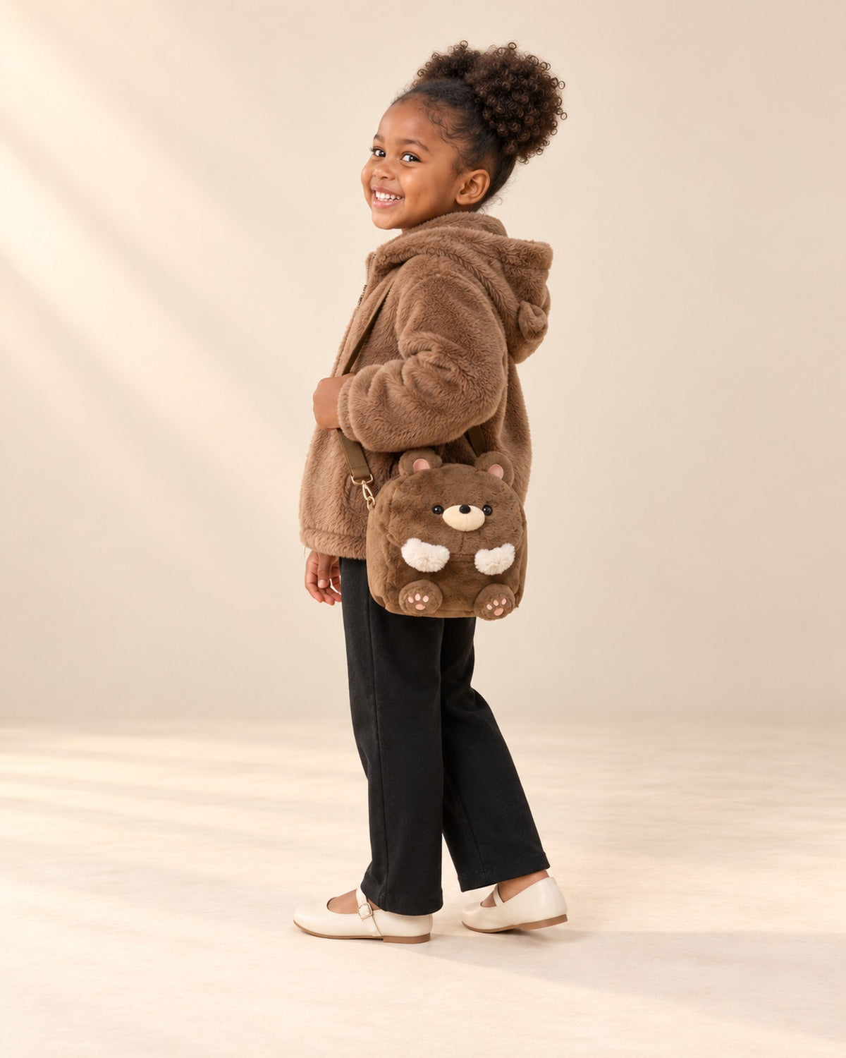 Side view of the teddy bear bag at the hip with the faux fur jacket – Brown