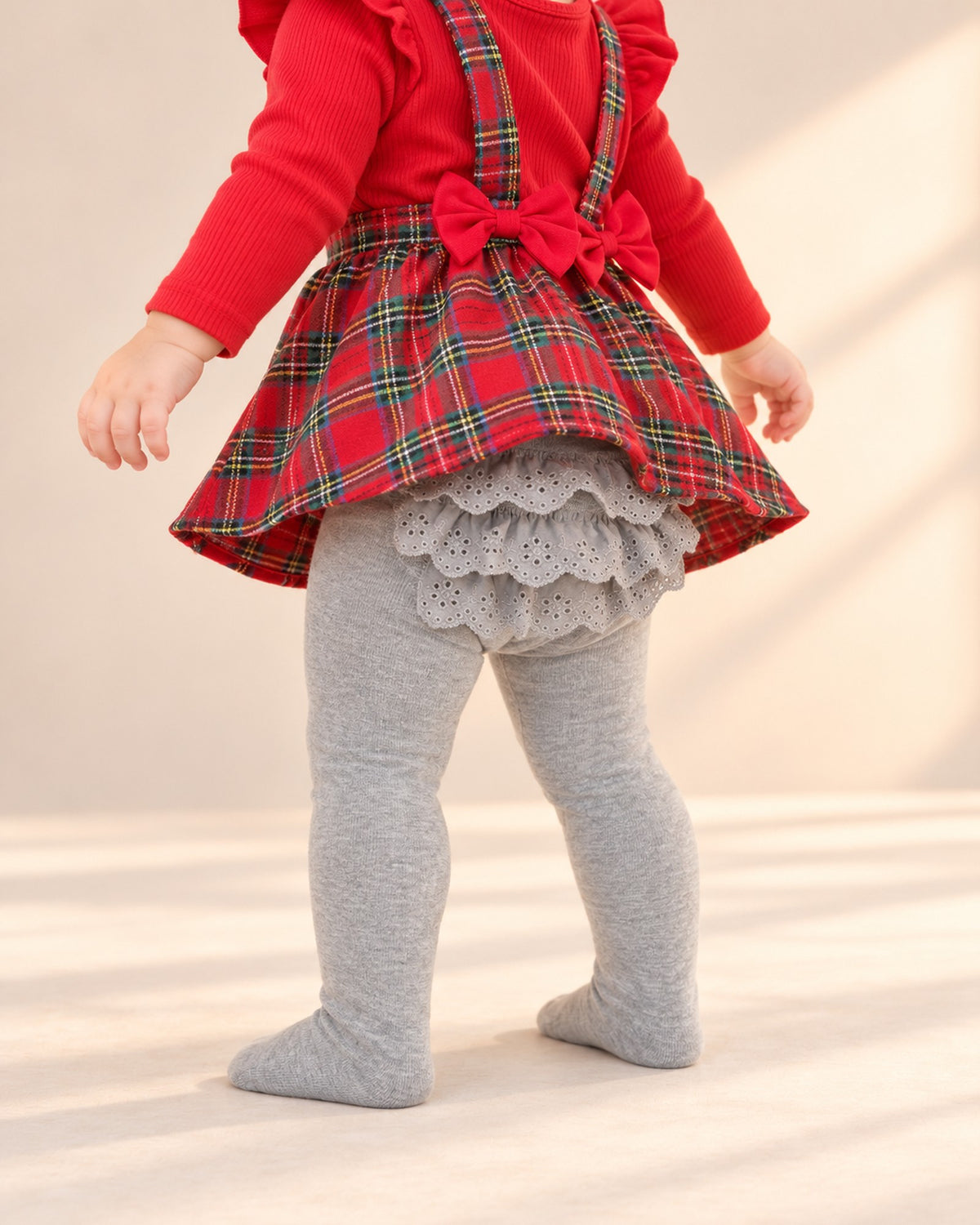 Close-up of the eyelet lace ruffles on the seat of the grey tights – Grey