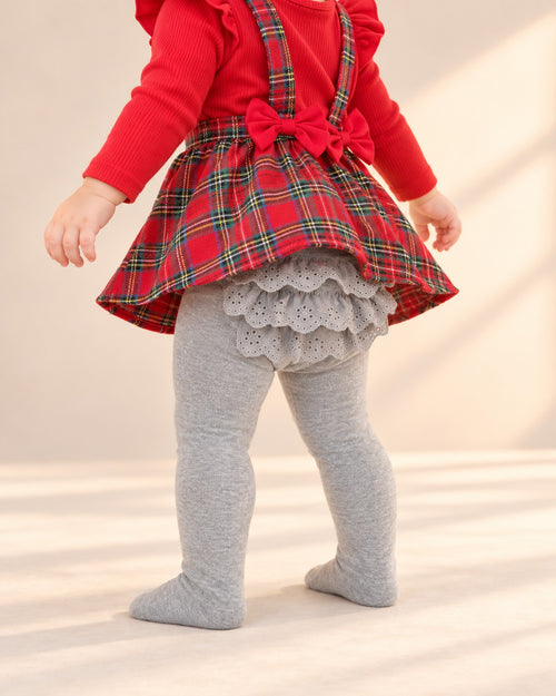 Close-up of the eyelet lace ruffles on the seat of the grey tights – Grey