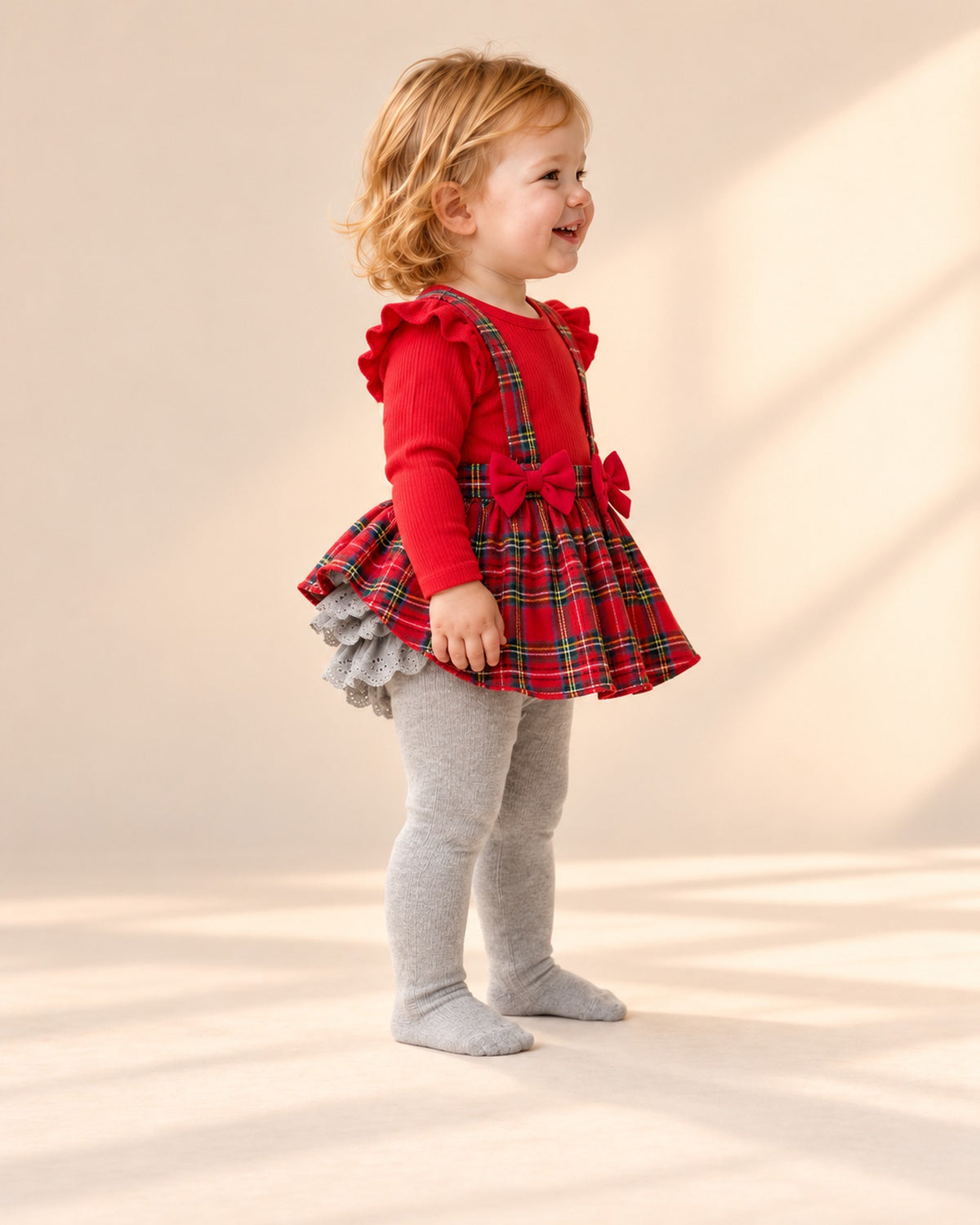 Side view showing the ruffle tiers peeking out under the tartan skirt – Grey