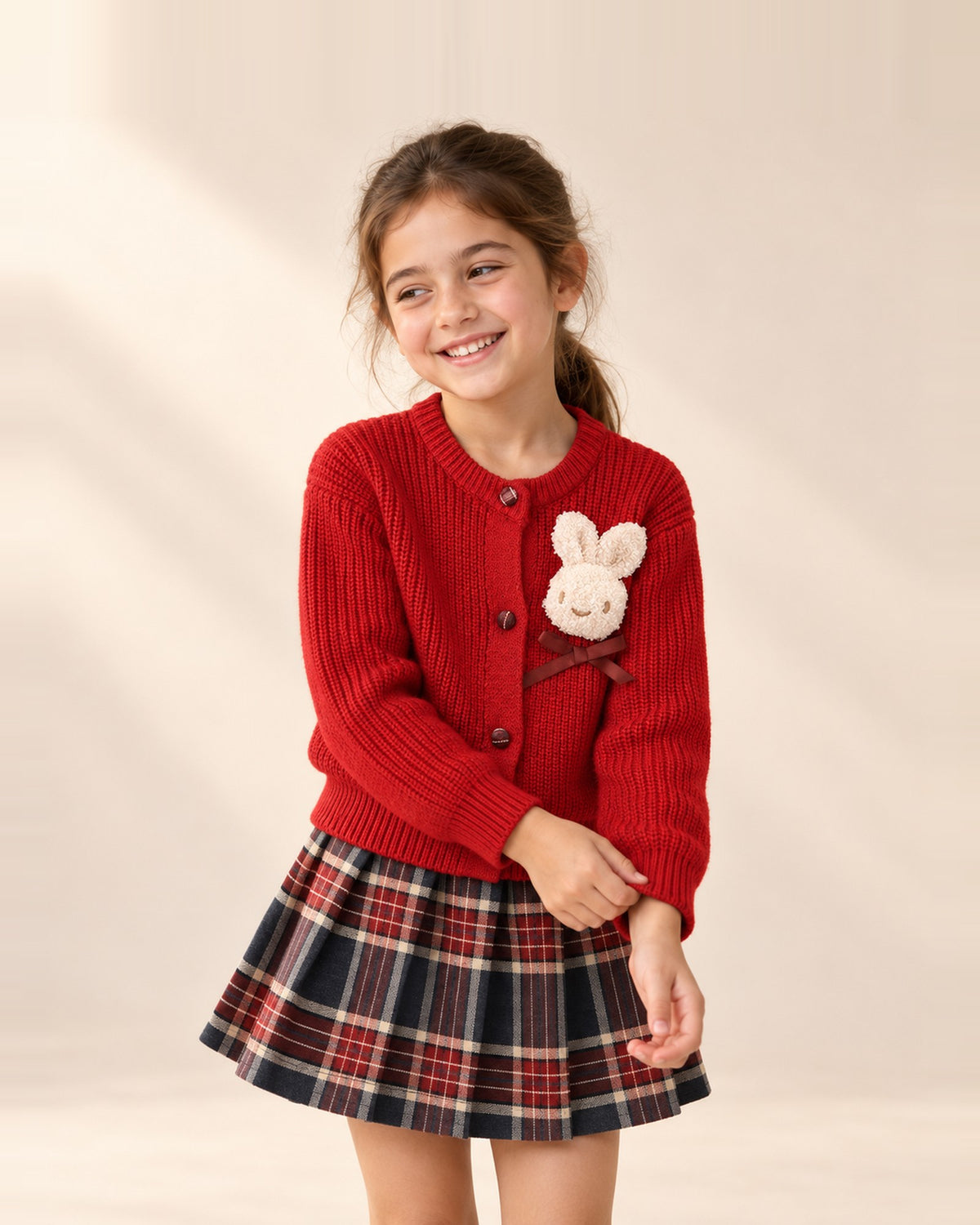 Girl in the Holly red bunny cardigan and tartan skirt set – Red
