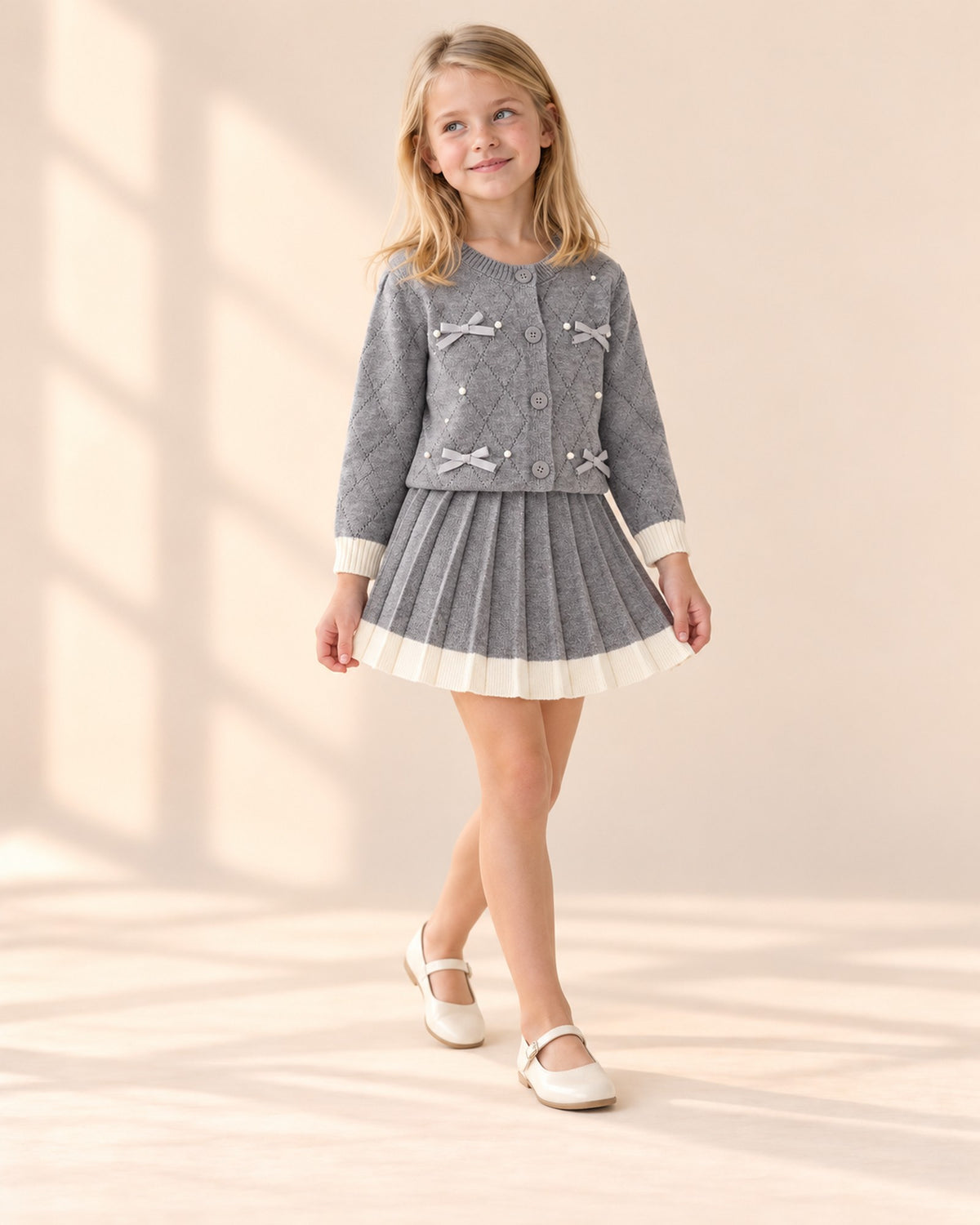 Girl smiling in the gray knit set with cream trim – Grey