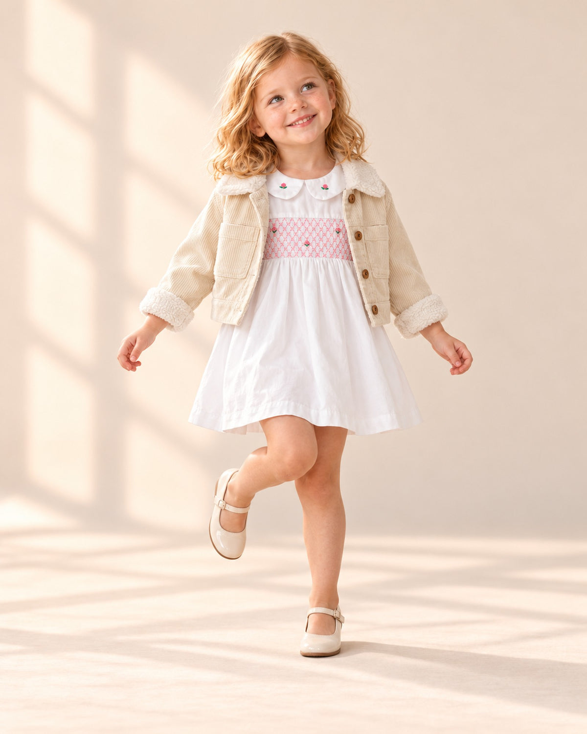 Girl posing in the white dress with pink smocking – White