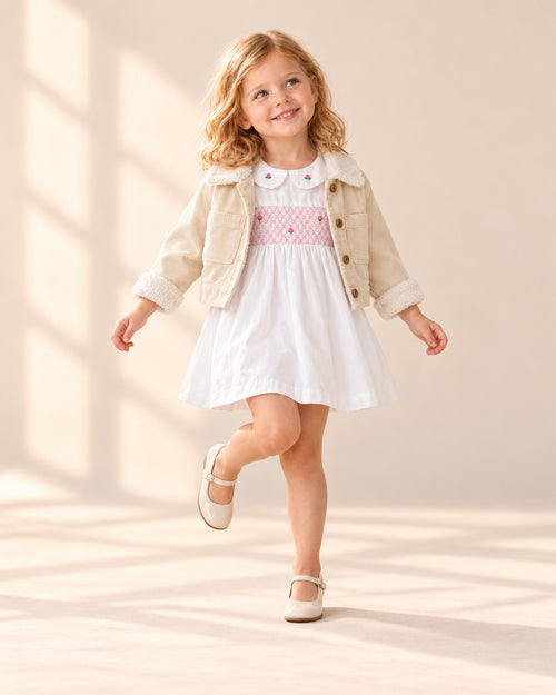 Girl posing in the white dress with pink smocking – White