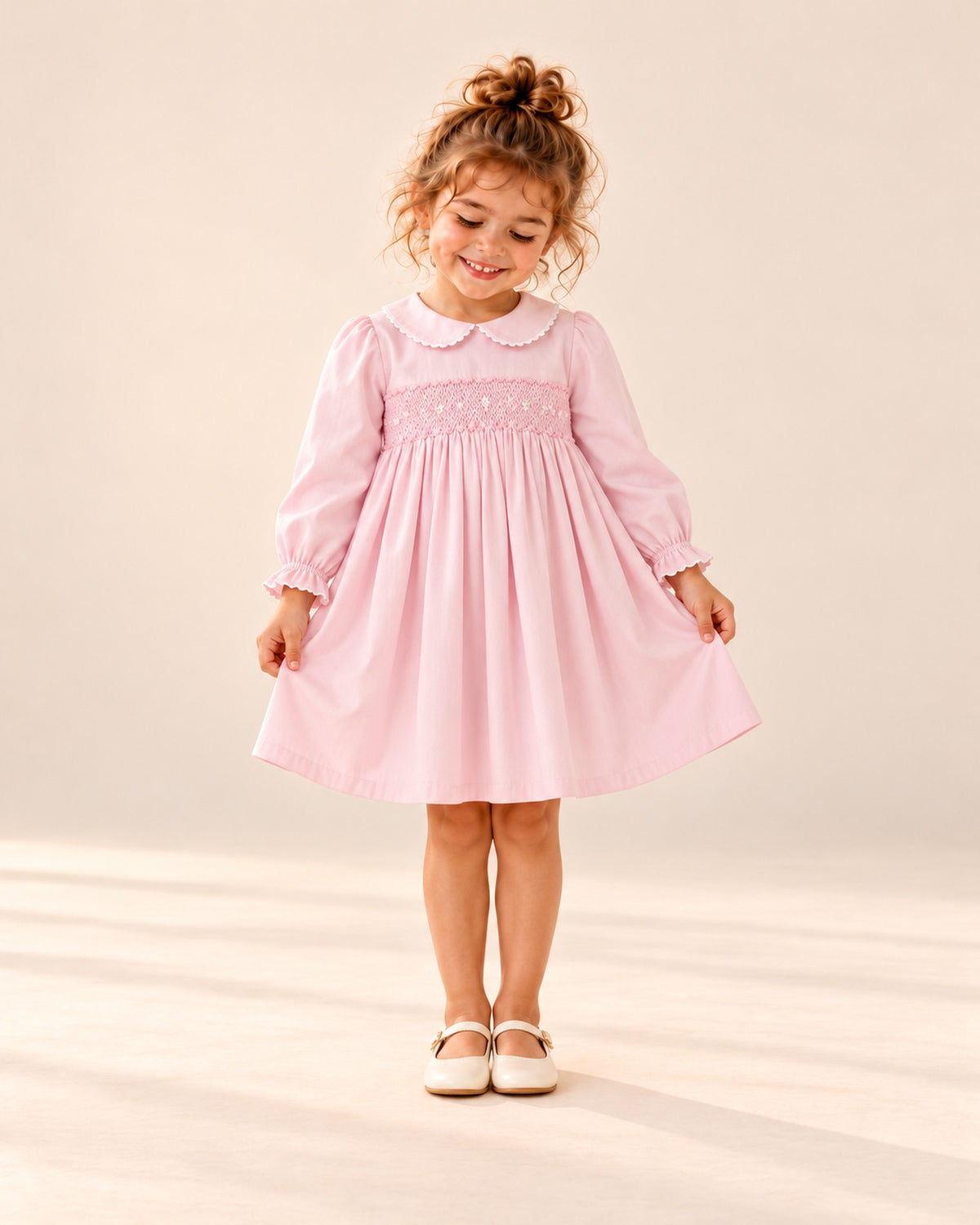 Front view of the pink long-sleeve smocked dress, full length – Pink