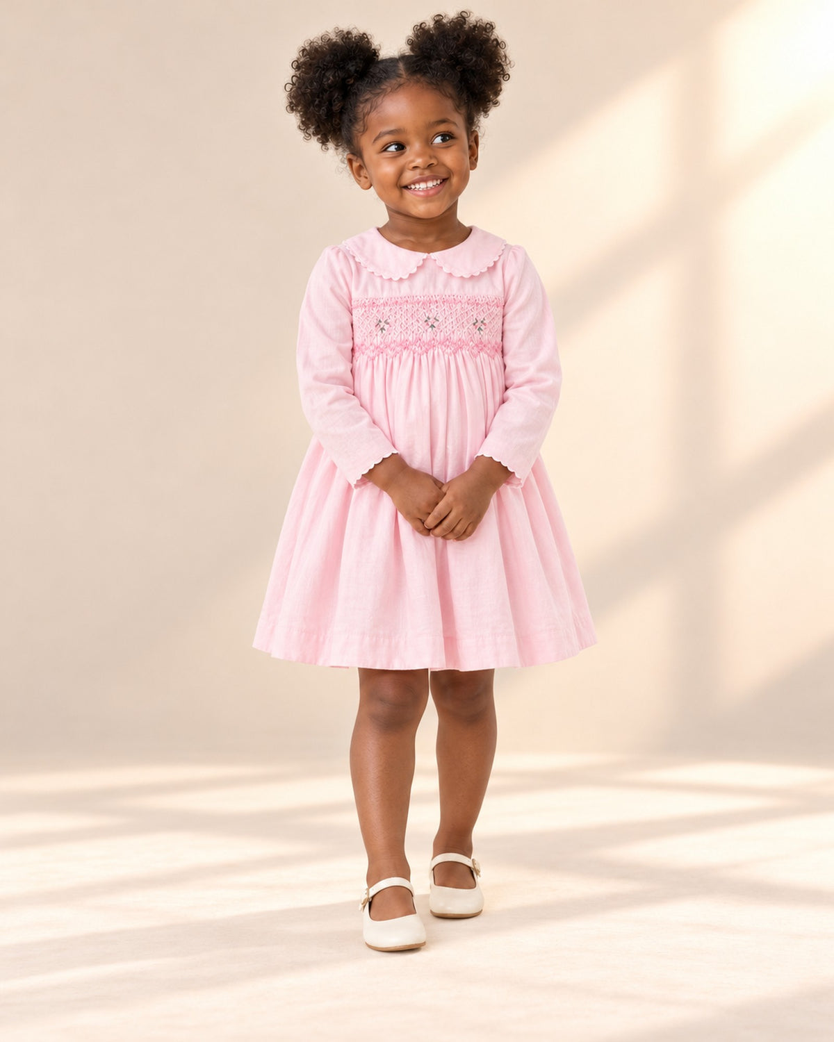Front view of the long-sleeve embroidered smock dress, full length – Light Pink