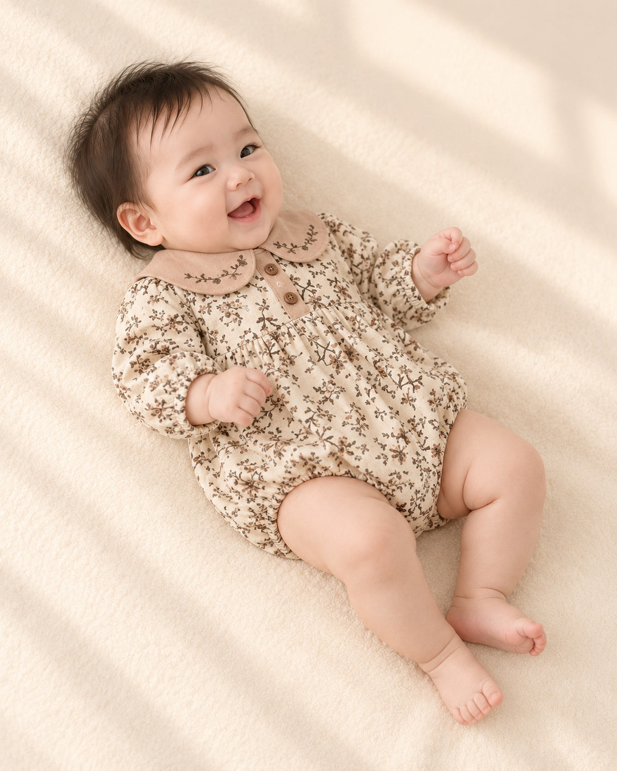 Side view showing the elastic legs and long sleeves – Cream Floral
