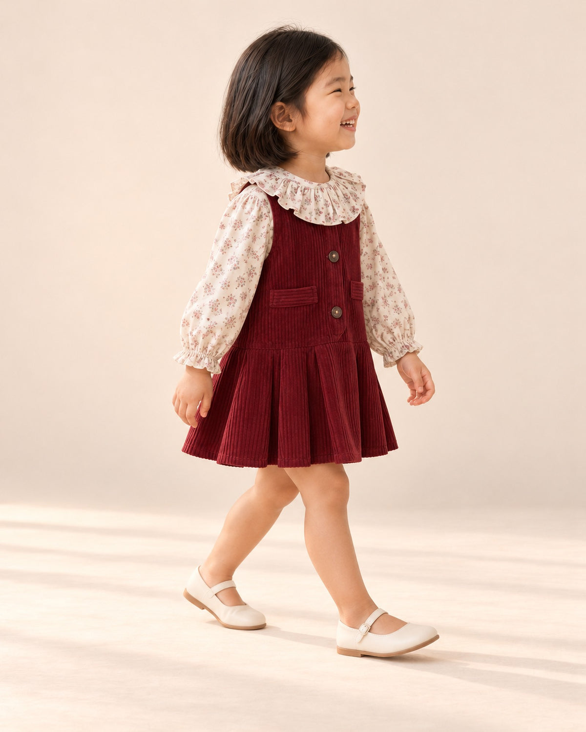 Side view showing the pleated corduroy skirt – Deep Red