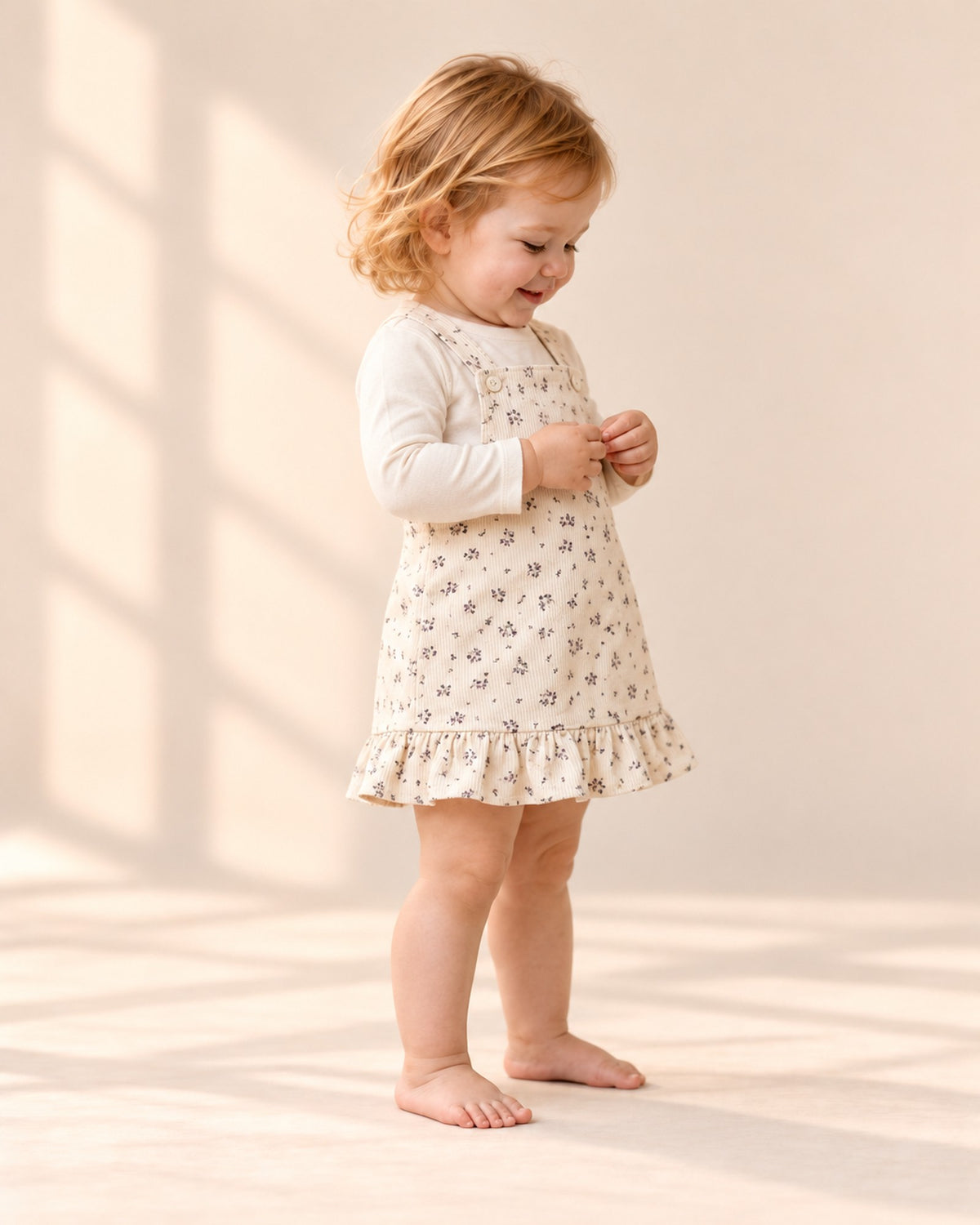 Wren Ruffle Hem Corduroy Pinafore in Cream Floral – side view