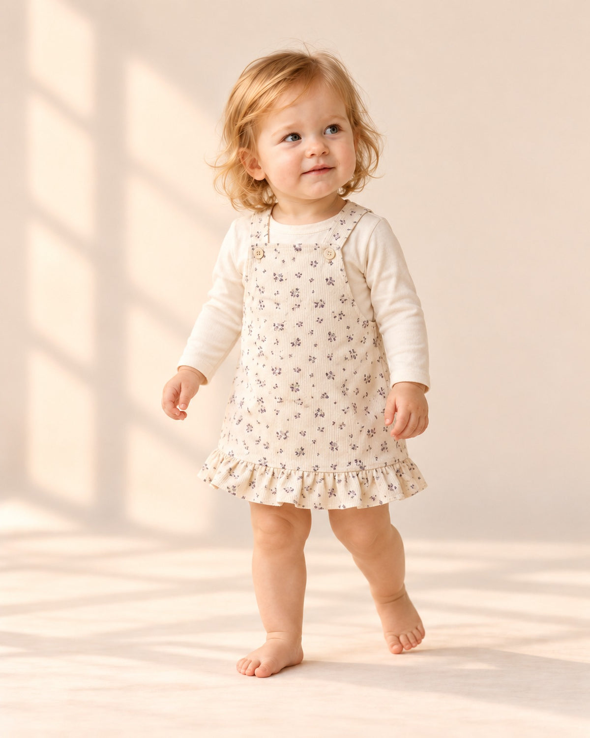Wren Ruffle Hem Corduroy Pinafore in Cream Floral – natural pose