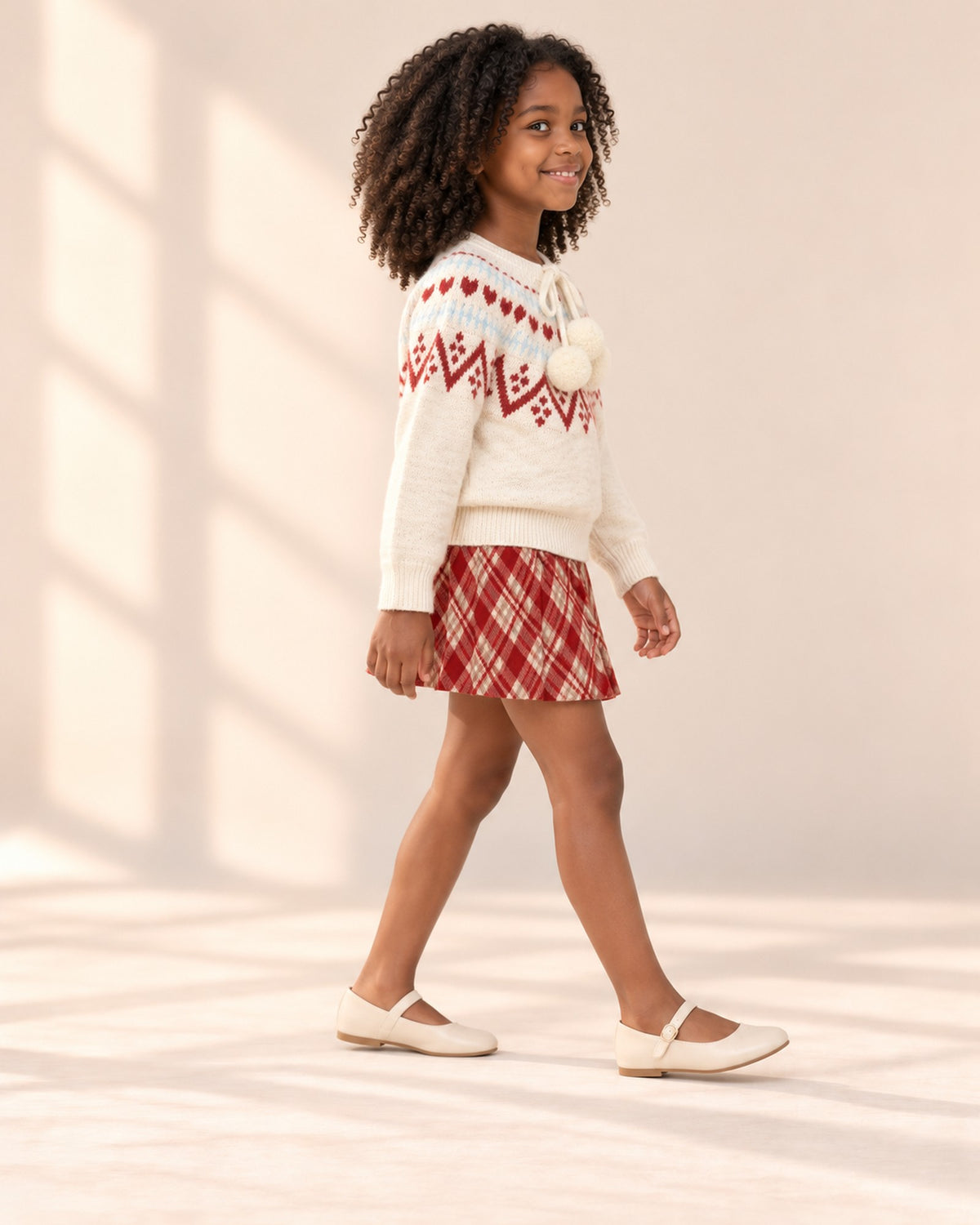 Side view of the sweater and skirt set mid-step – Cream & Red
