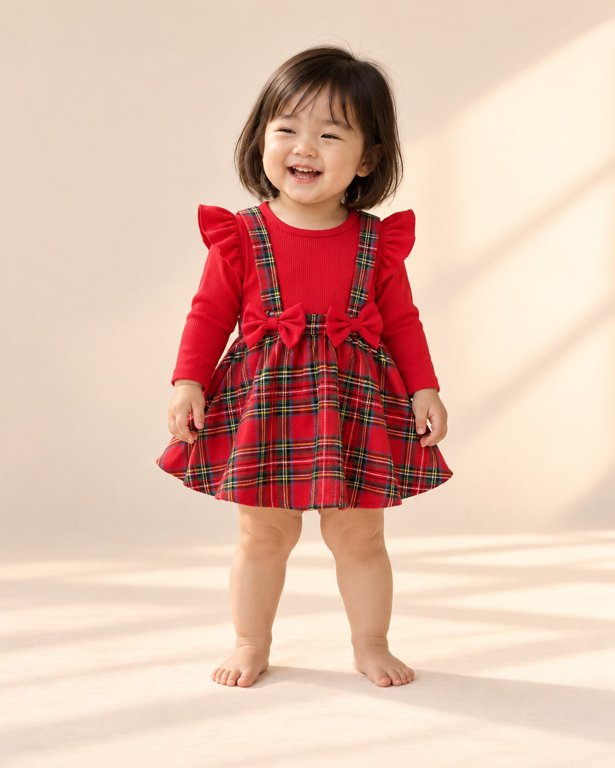 Full-length front view of the tartan bow romper dress – Red Tartan