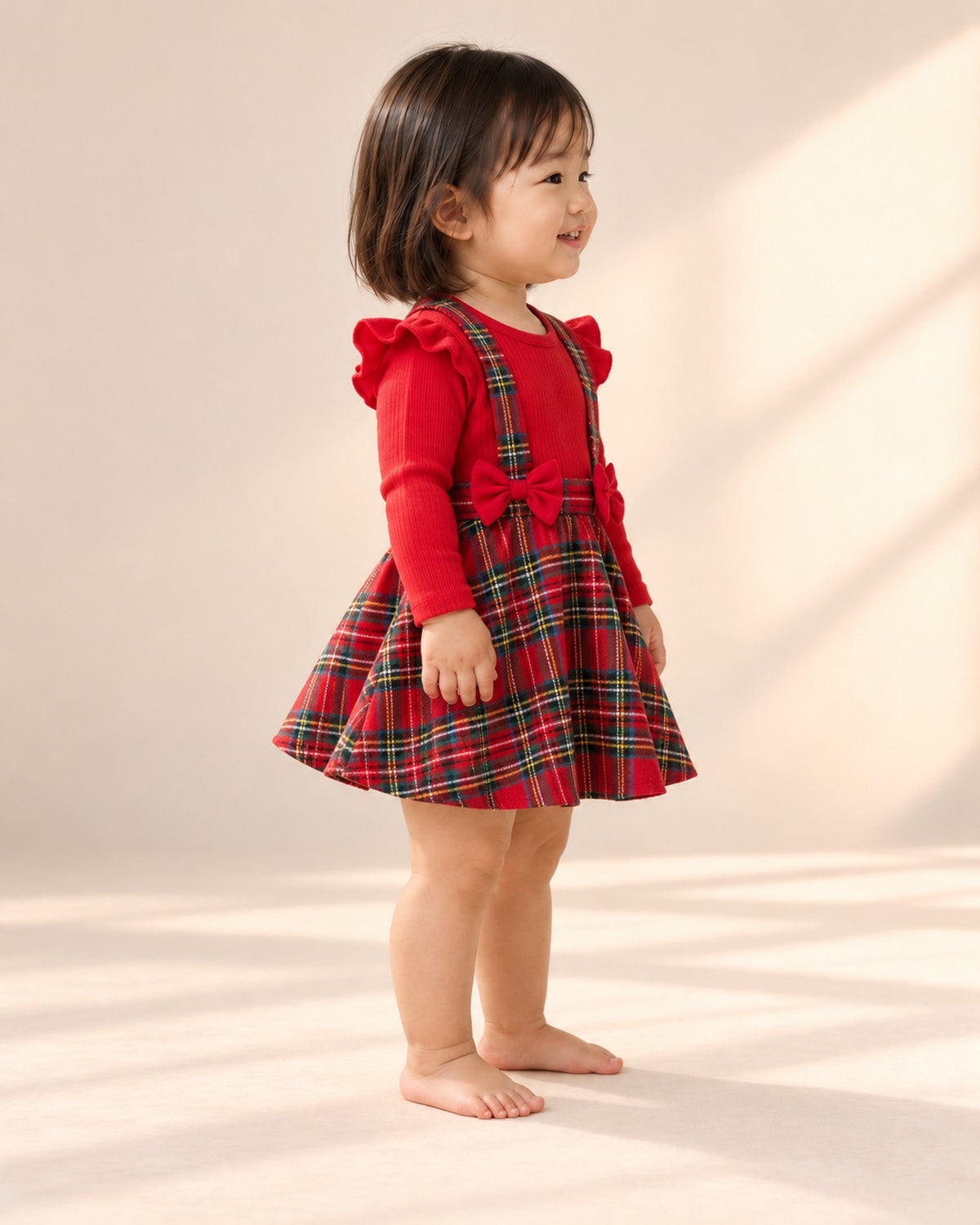 Side view of the tartan bow romper dress – Red Tartan