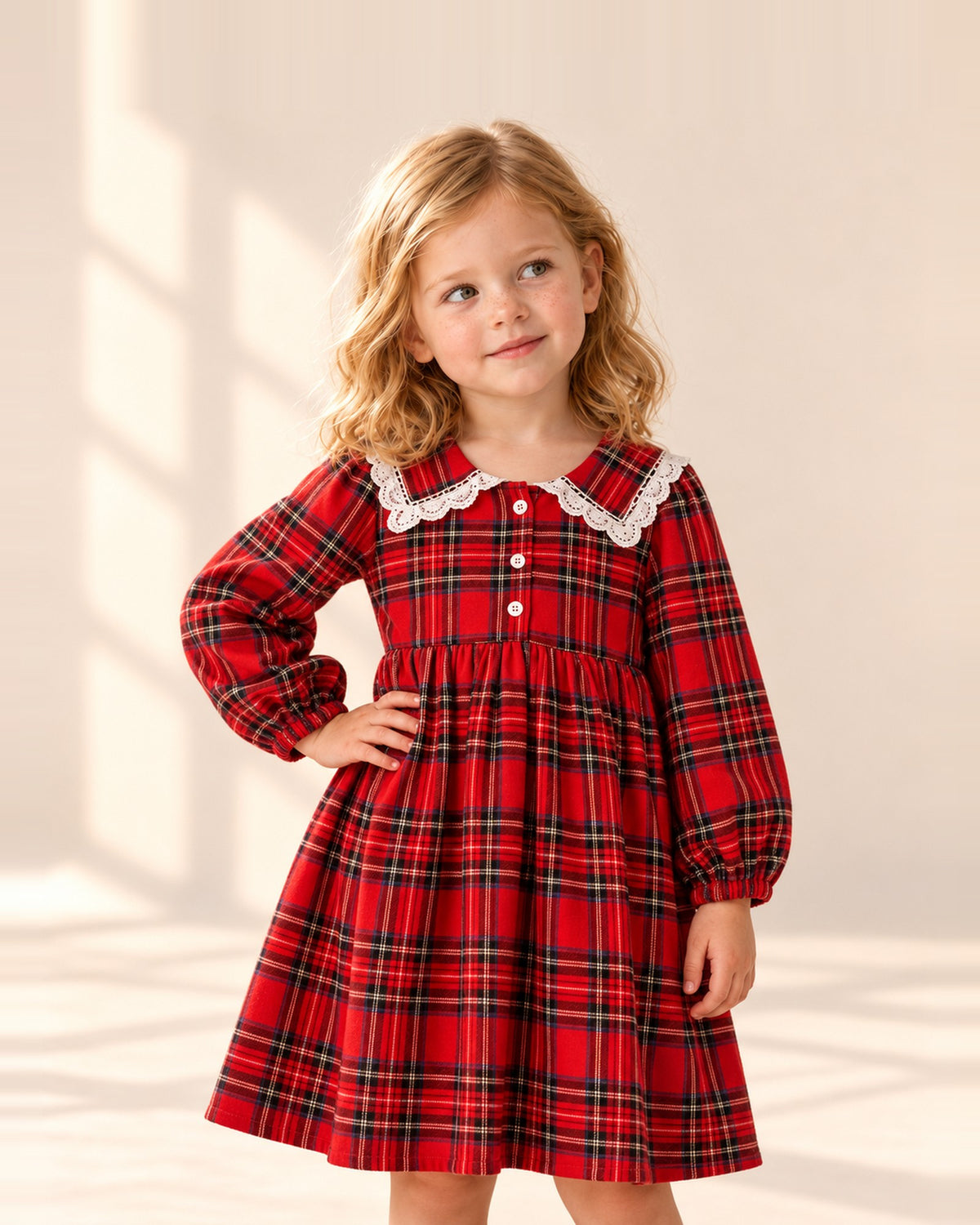 Girl in the Libby red tartan dress with a white lace collar, hand on hip – Red Tartan