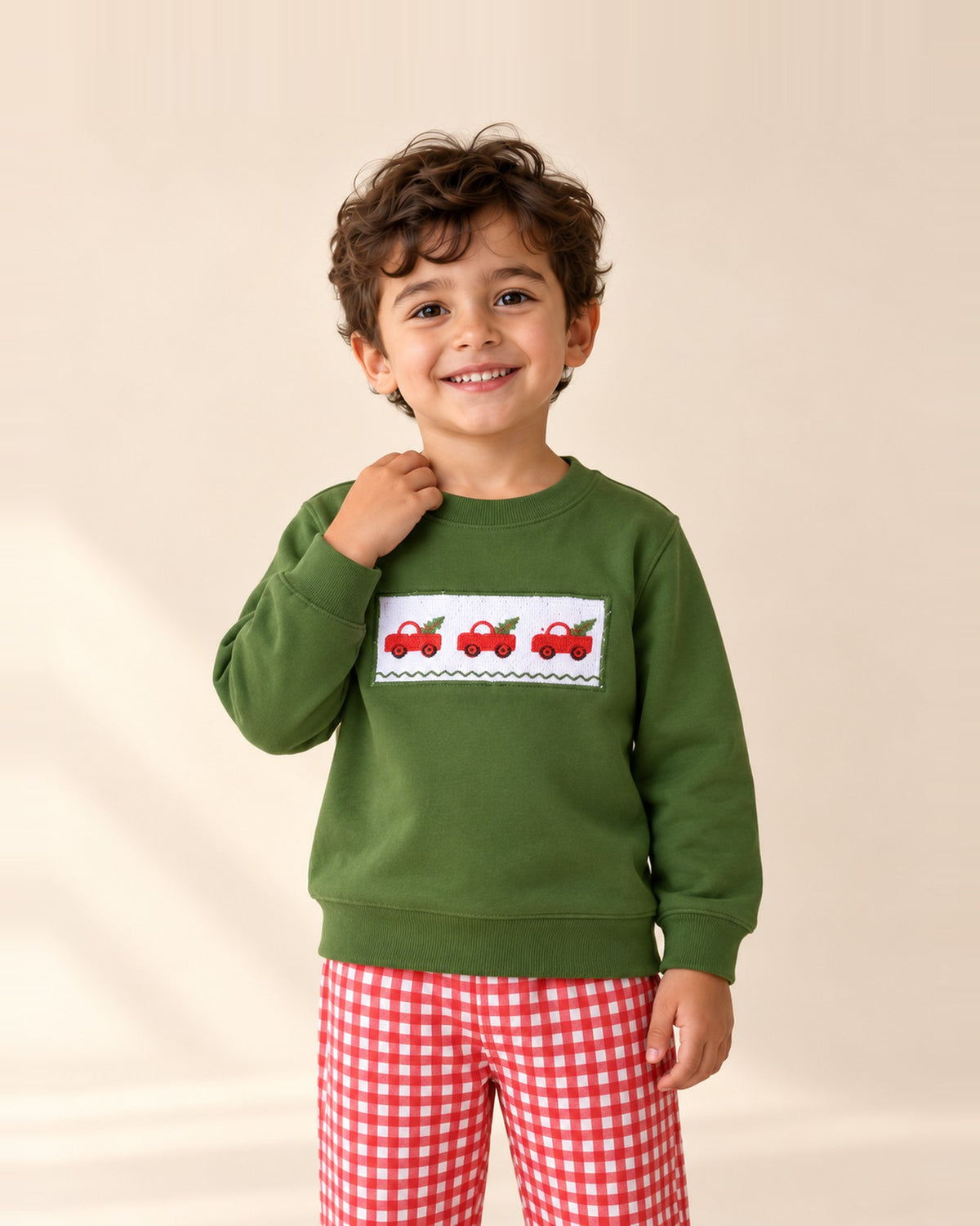 Boy in the Bertie green Christmas truck sweatshirt and gingham pants – Green & Red