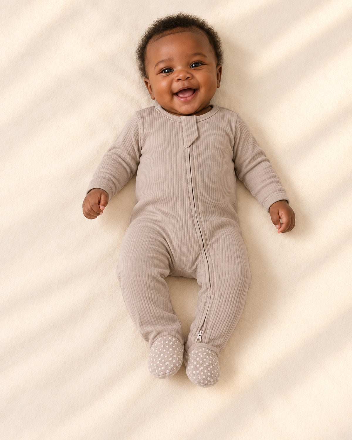 Front view of the ribbed footie with two-way zipper – Taupe