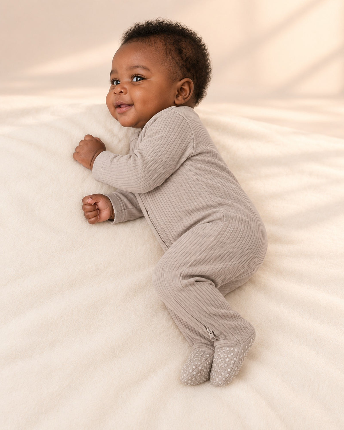 Side view of the taupe footie showing the footed legs – Taupe
