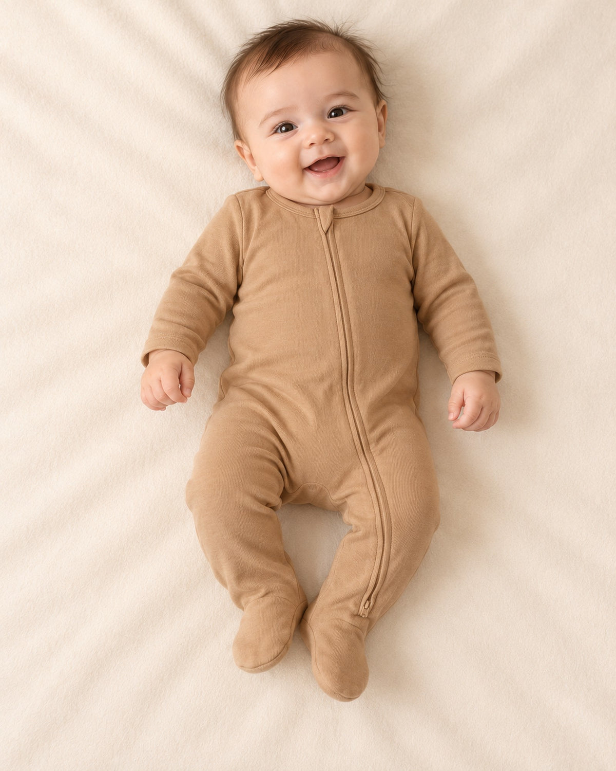 Close-up of the camel ribbed baby footie showing the two-way front zip and covered feet – Camel