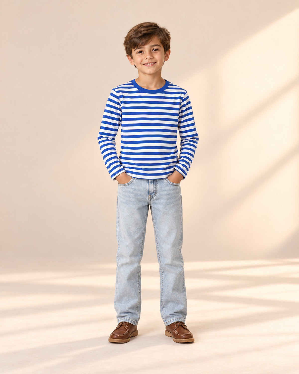Front view of a child in light wash straight jeans and a blue-and-white Breton stripe tee, full length – Light Wash