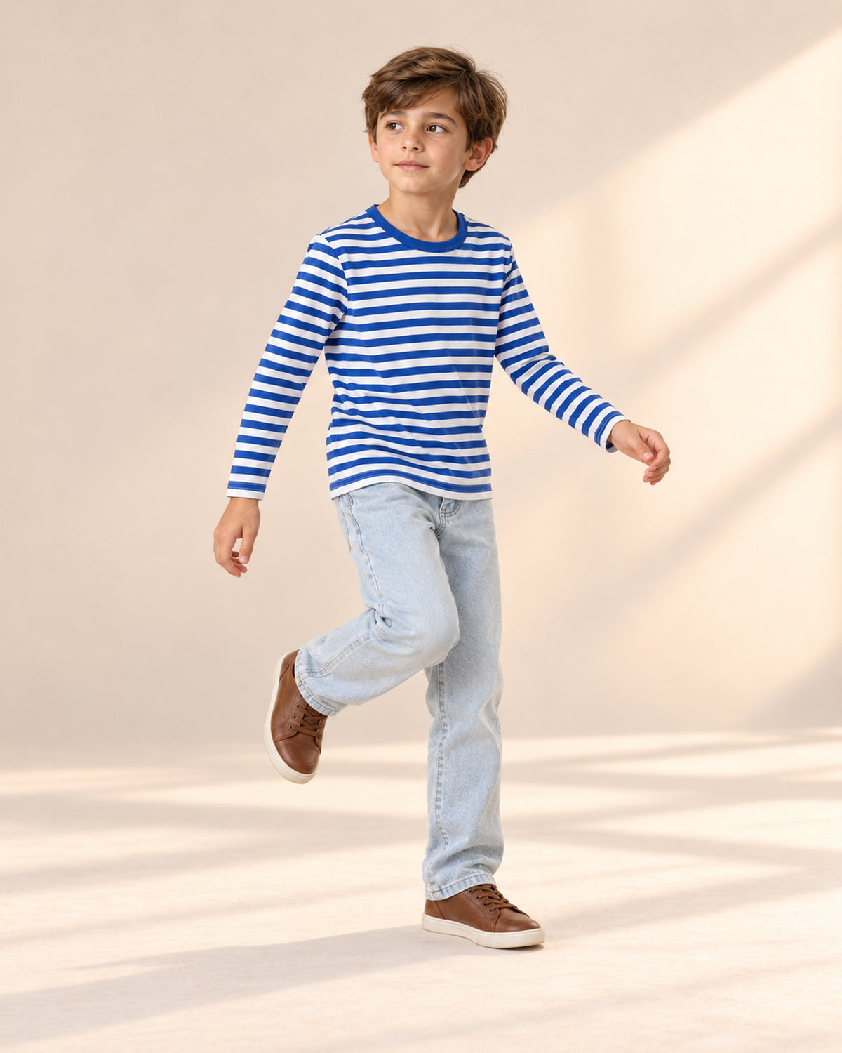 Child standing relaxed with hands in the pockets of the light wash jeans and striped tee – Light Wash