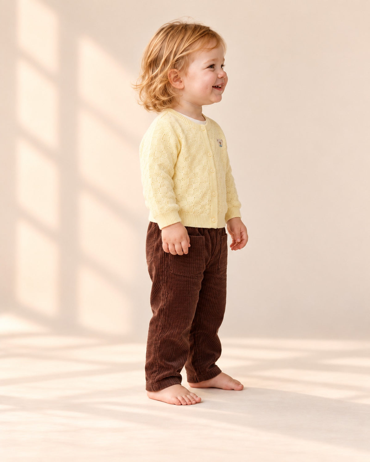 Side view of the brown corduroy pants with the yellow knit cardigan – Brown