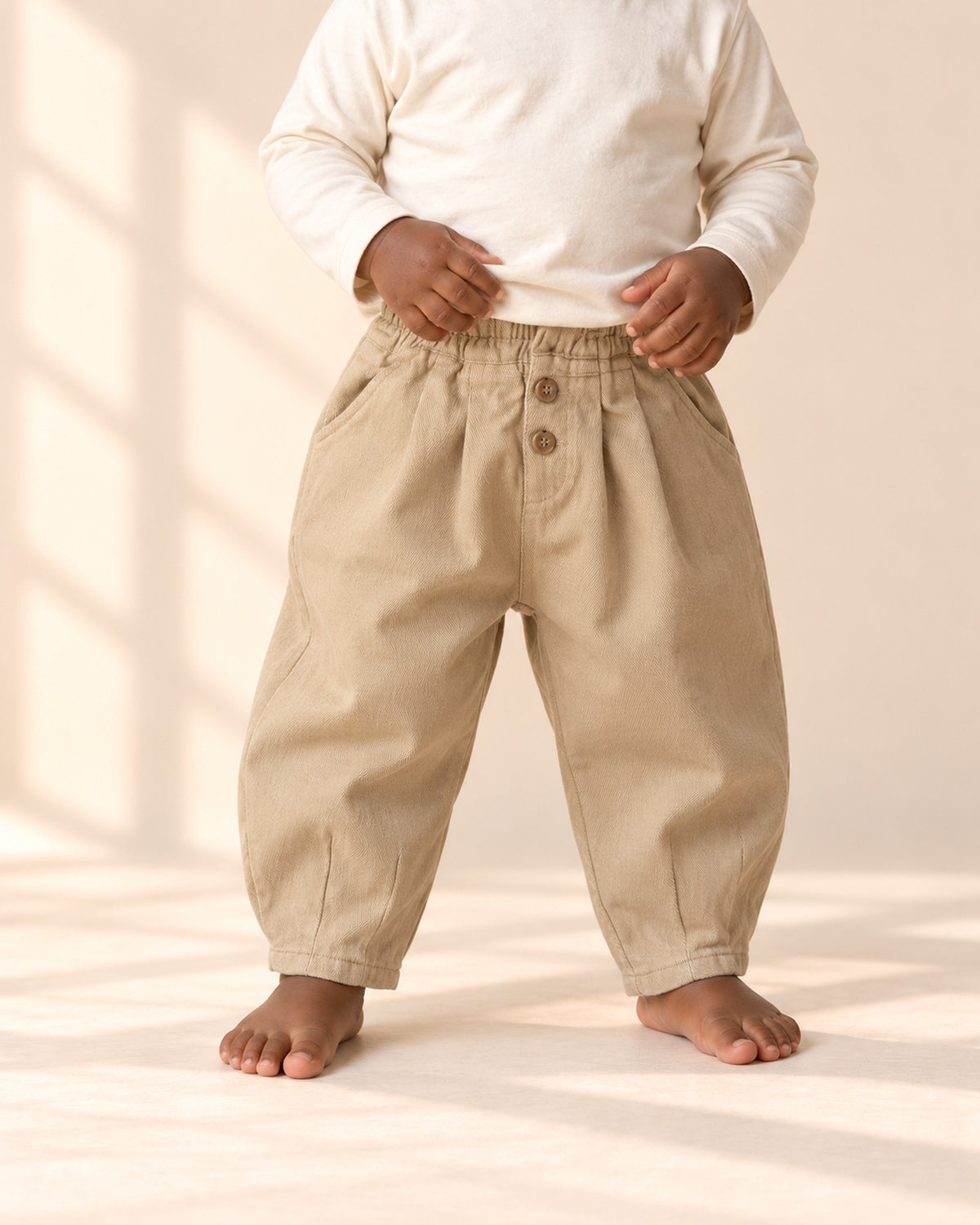 Close-up from chest to feet of khaki balloon pants with two buttons at the waist – Khaki