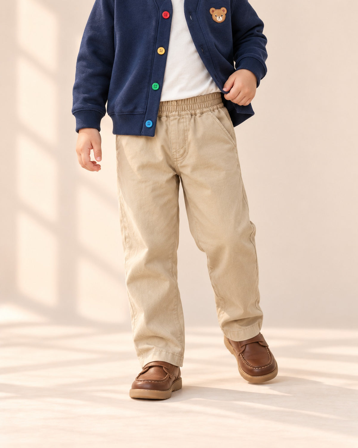 Close-up from chest to feet of khaki chinos with an elastic waist and slanted pockets – Khaki