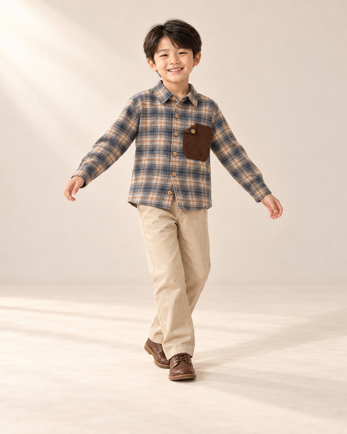 Boy leaning against a wall in classic khaki chinos – Khaki