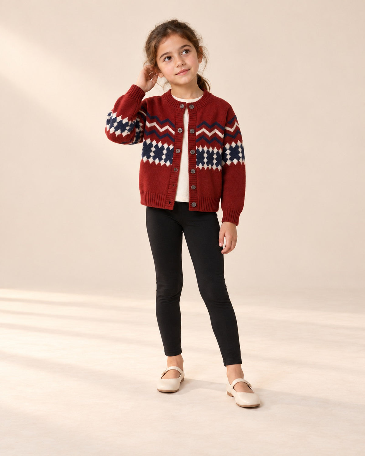 Front view of a girl in the black leggings and a red Fair Isle cardigan over a cream top, full length – Black