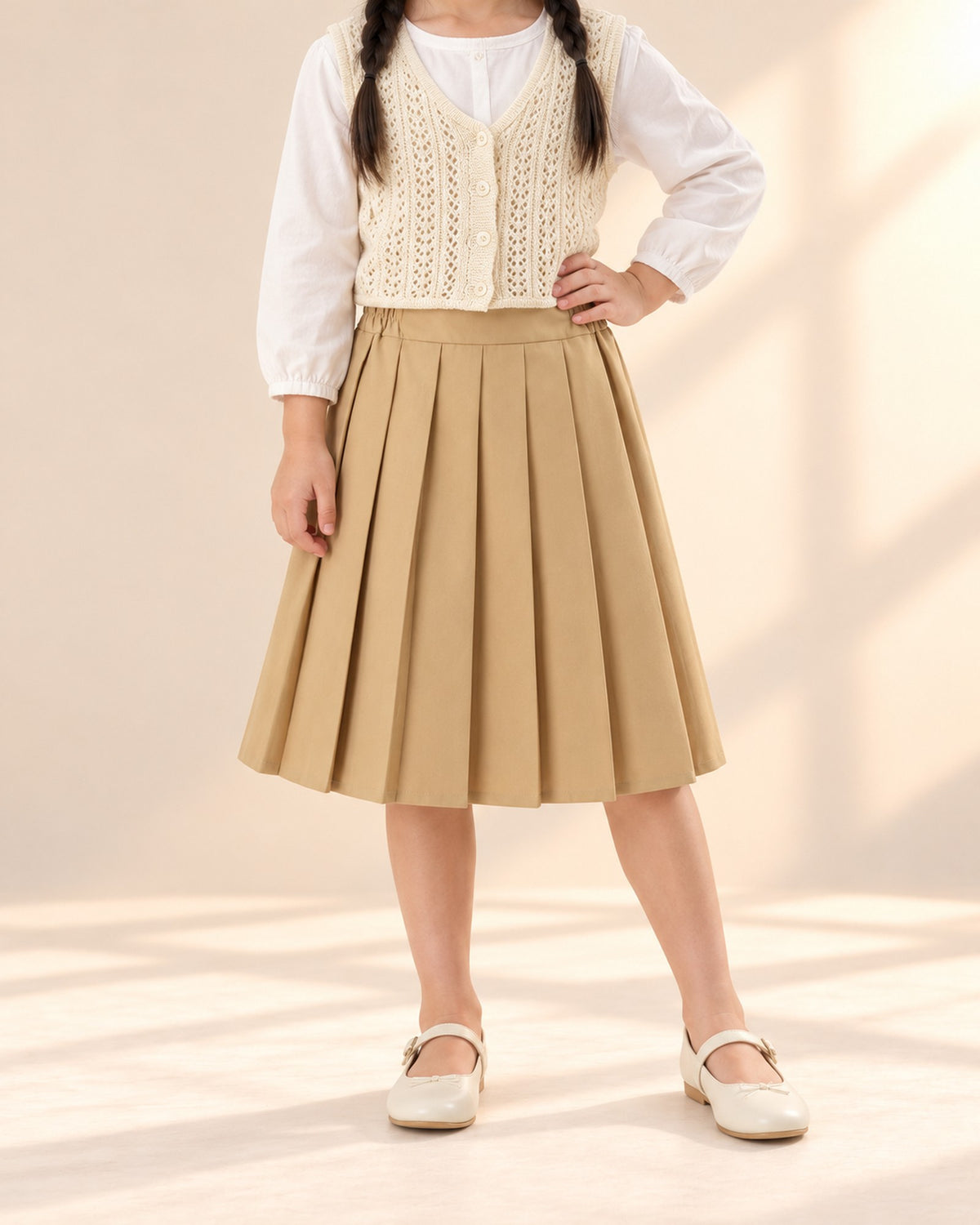 Close-up from waist to feet of a camel pleated midi skirt – Camel