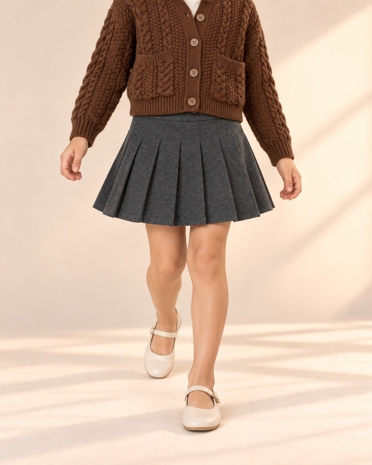 Close-up from waist to feet of a charcoal grey pleated skirt with a wide waistband – Charcoal