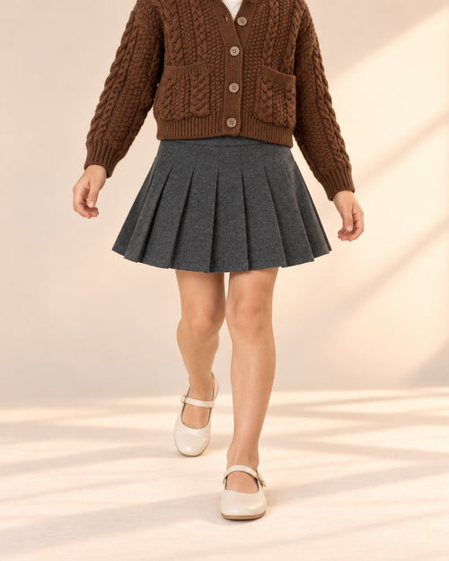 Close-up from waist to feet of a charcoal grey pleated skirt with a wide waistband – Charcoal
