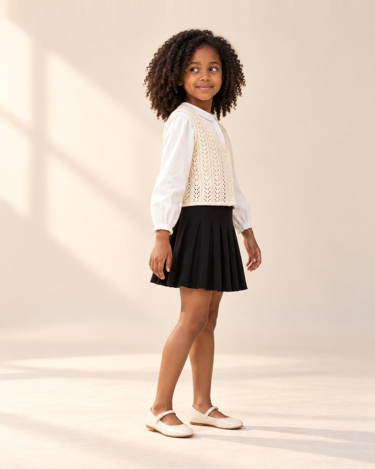 Side view of the flared black knit skirt with the crochet vest – Black