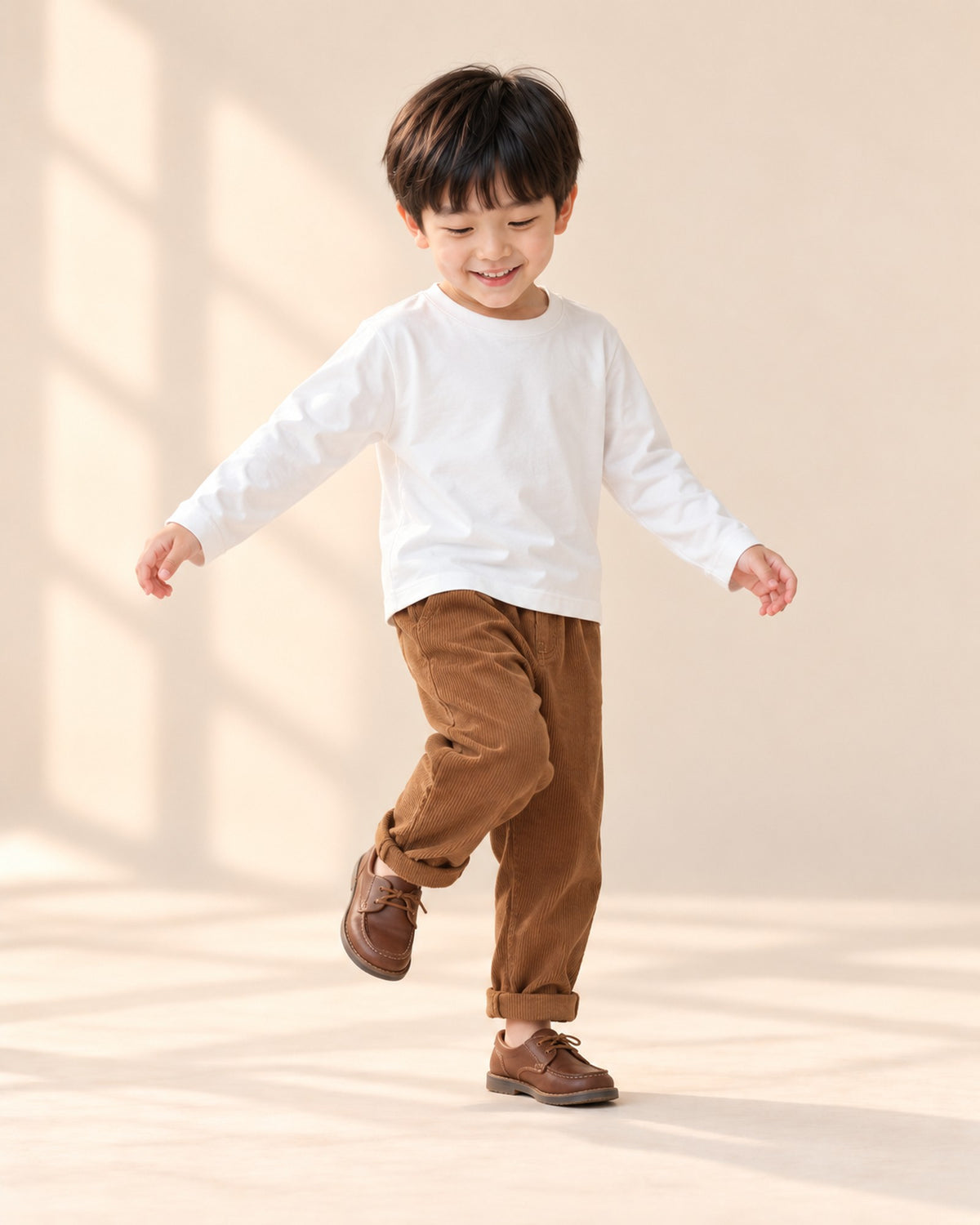 Boy in the heavyweight white tee and brown corduroy pants, standing at ease – White