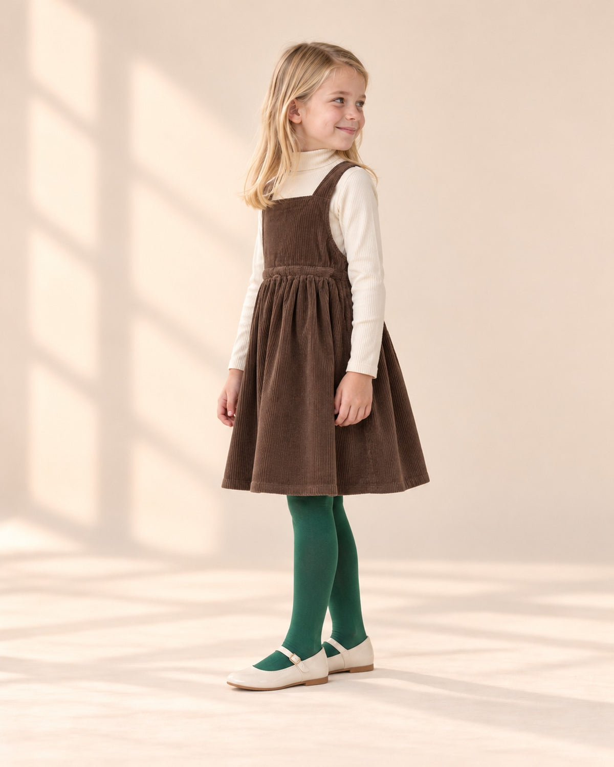 Side view of the turtleneck showing the fitted sleeves and short collar – Cream