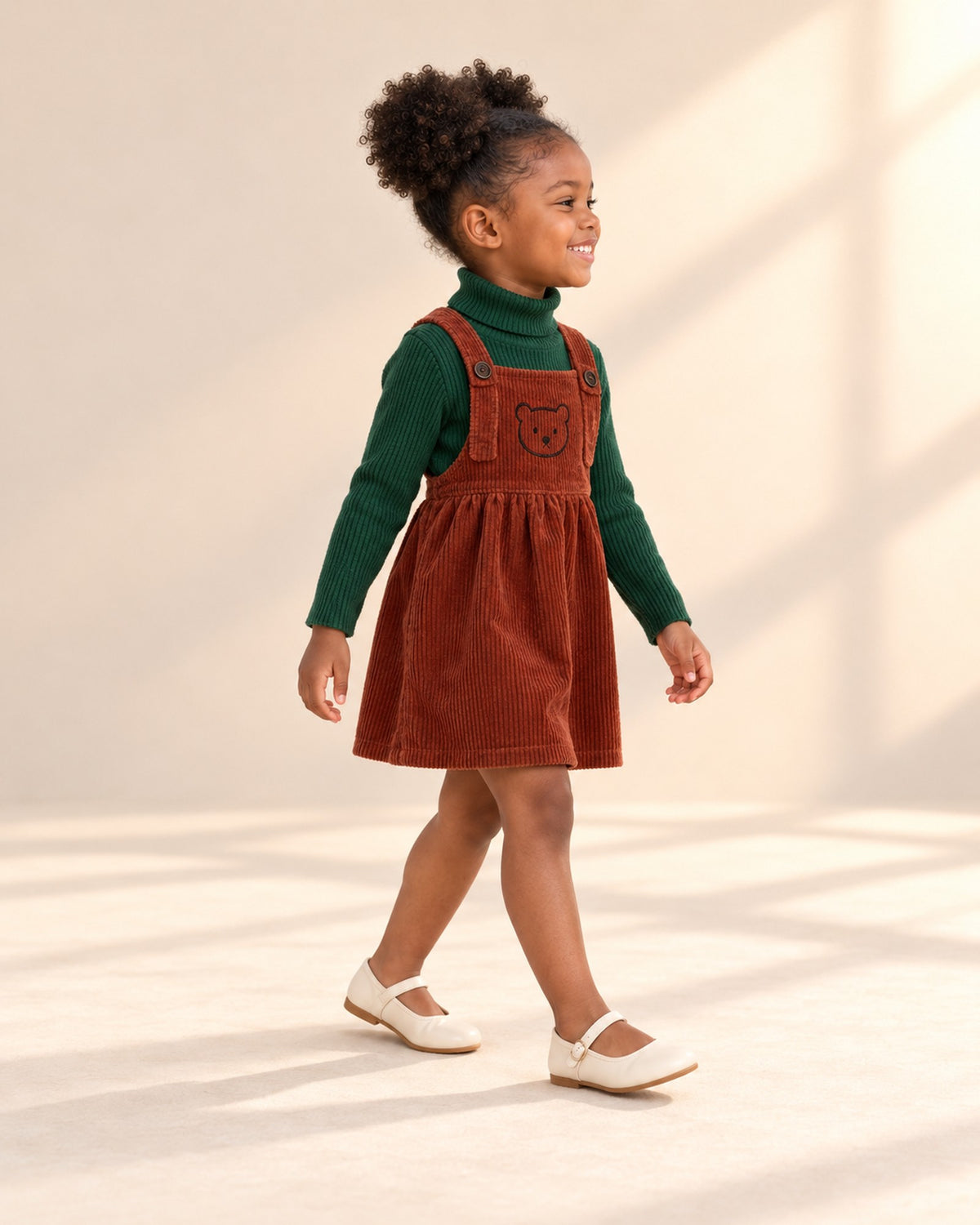 Side view of the green turtleneck sleeves with the rust pinafore – Forest Green